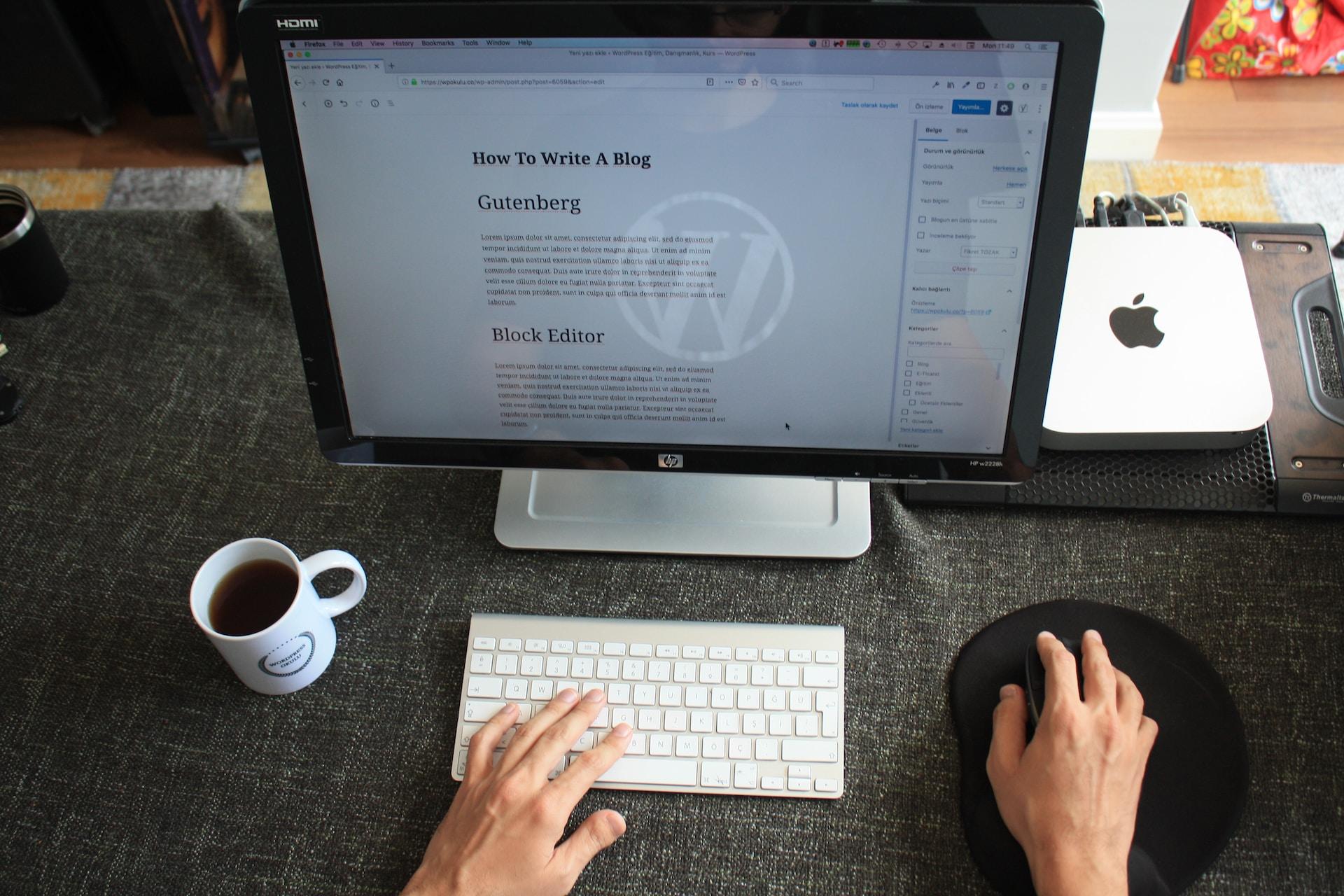 persoon achter laptop om een WordPress blog te maken (alleen handen zichtbaar)